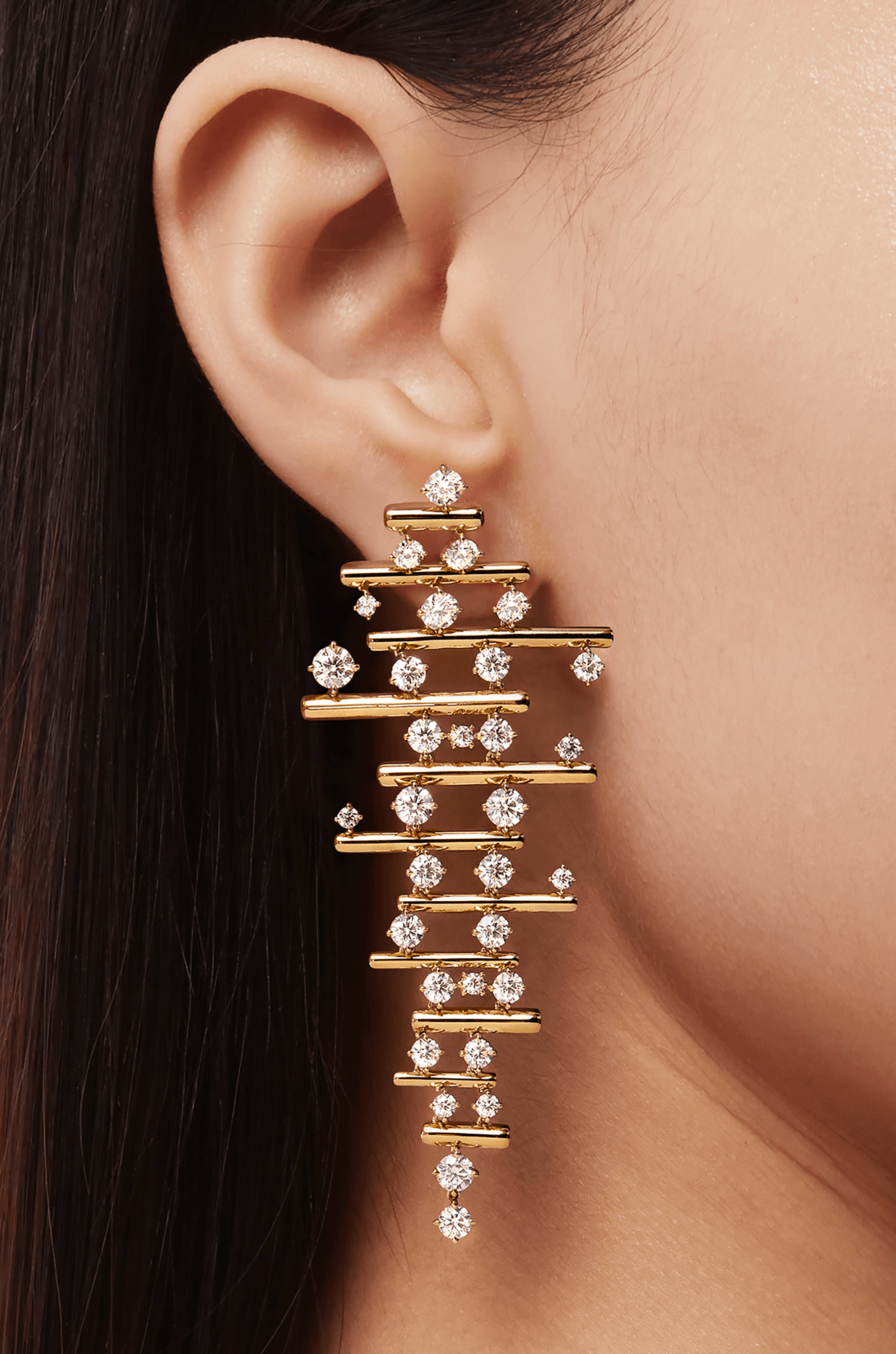 A gold jhumka earring before transformation